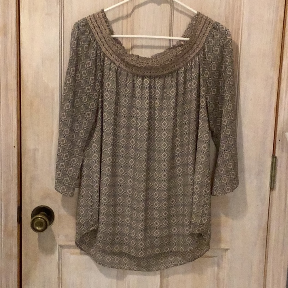 A pretty chiffon style lined blouse with delicate smocking around neckline